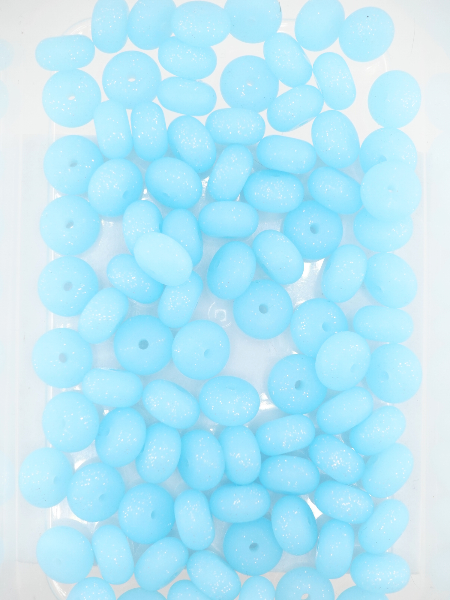 Collection of aqua blue colored silicone spacers with glitter