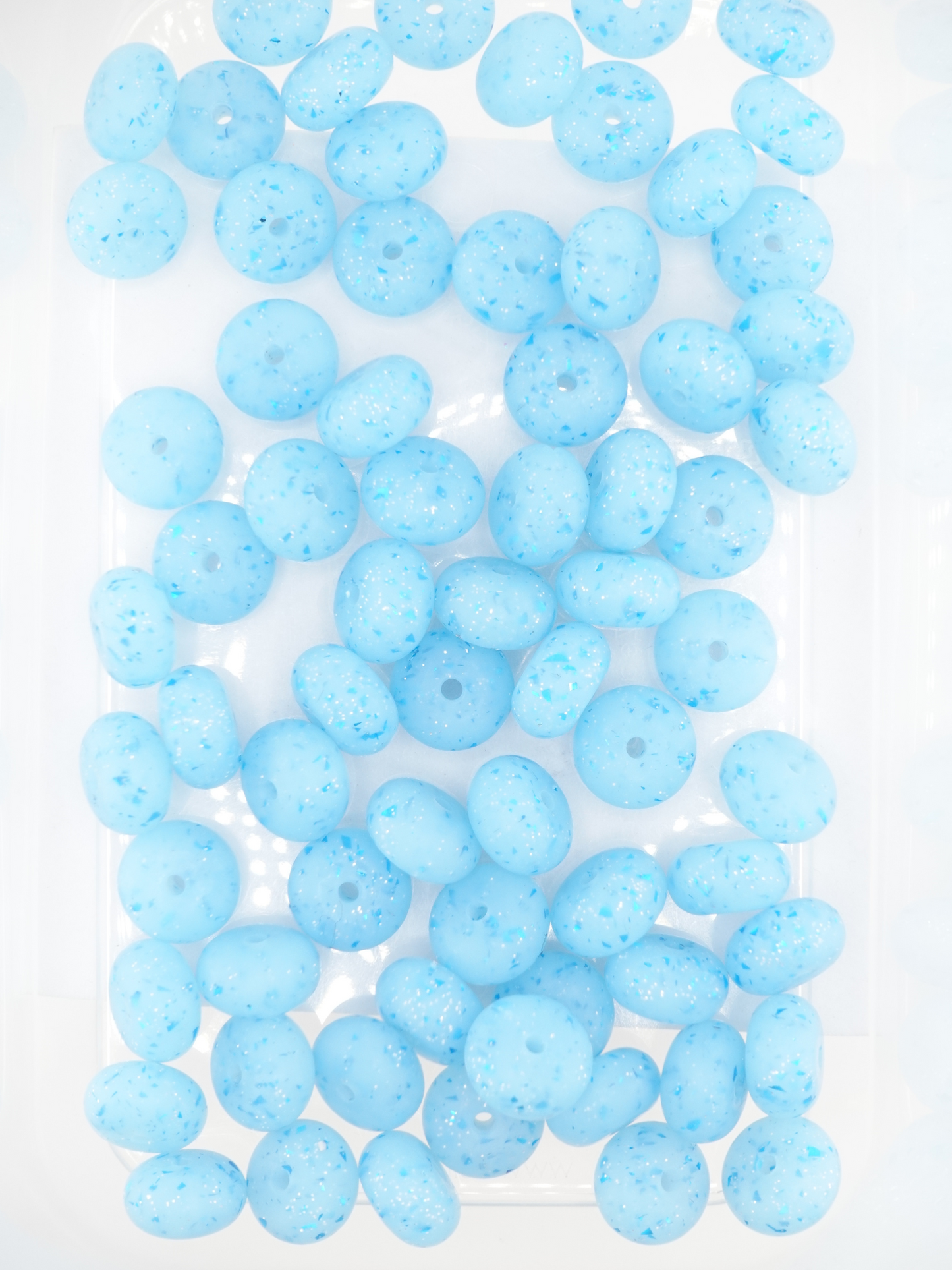 Collection of aqua blue silicone spacers with confetti design