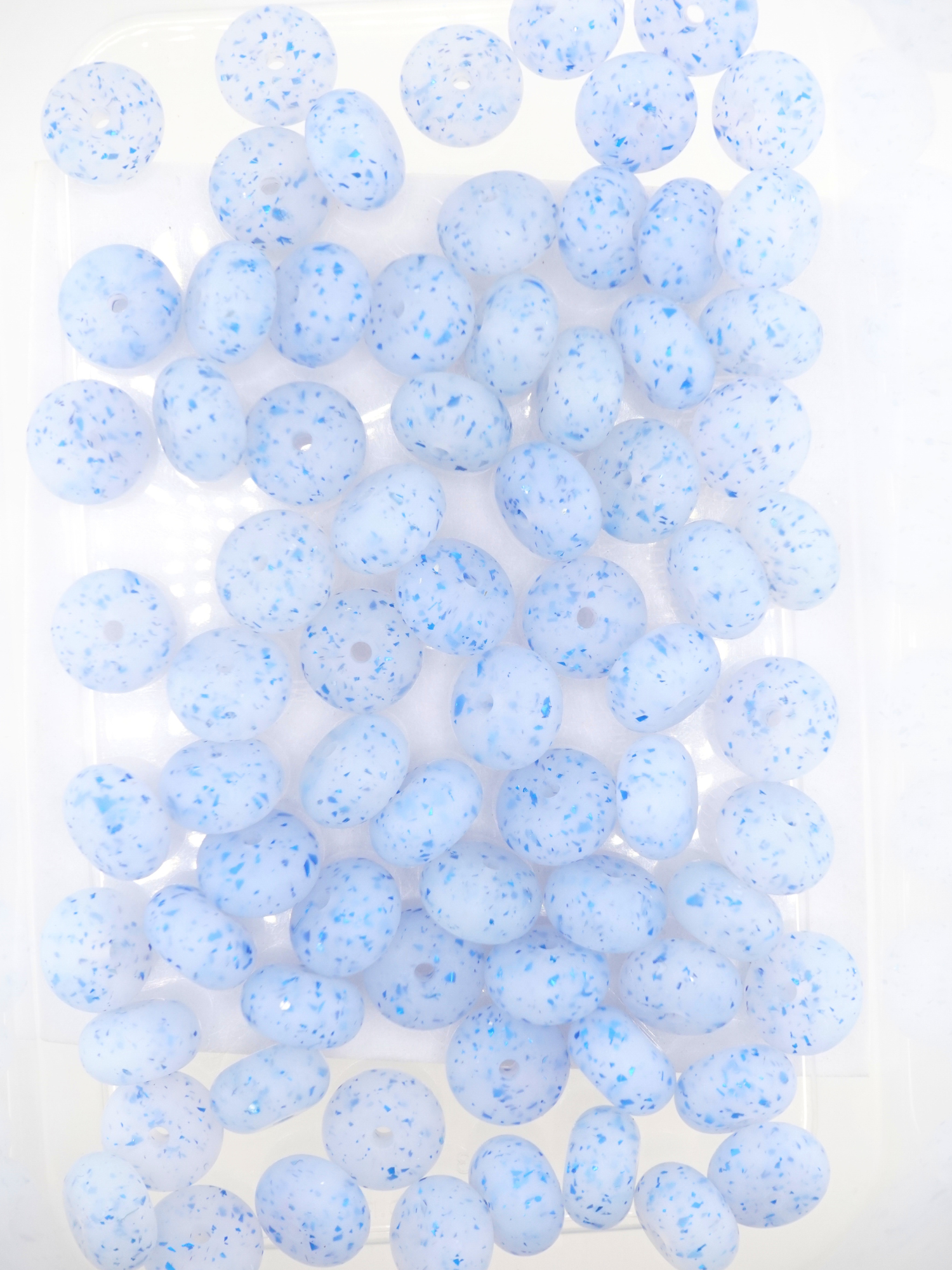 Collection of blue silicone spacers with confetti design and jelly finish