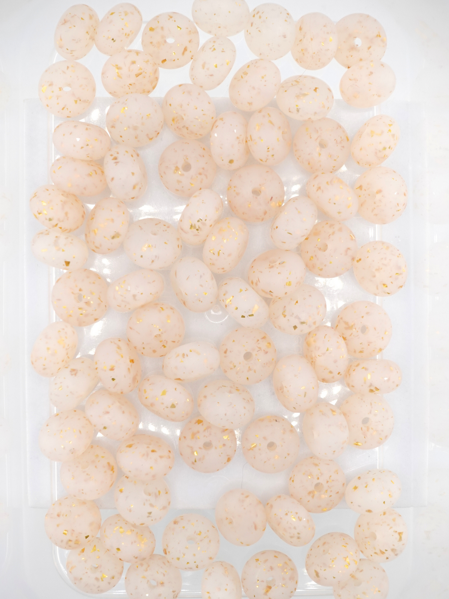 Collection of gold silicone spacers with confetti design and jelly finish