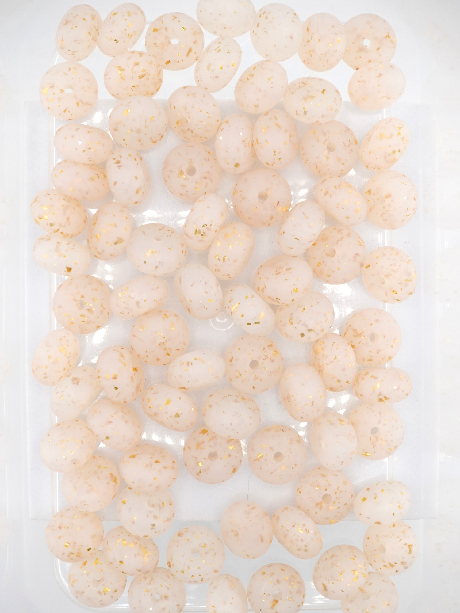 Collection of gold silicone spacers with confetti design and jelly finish