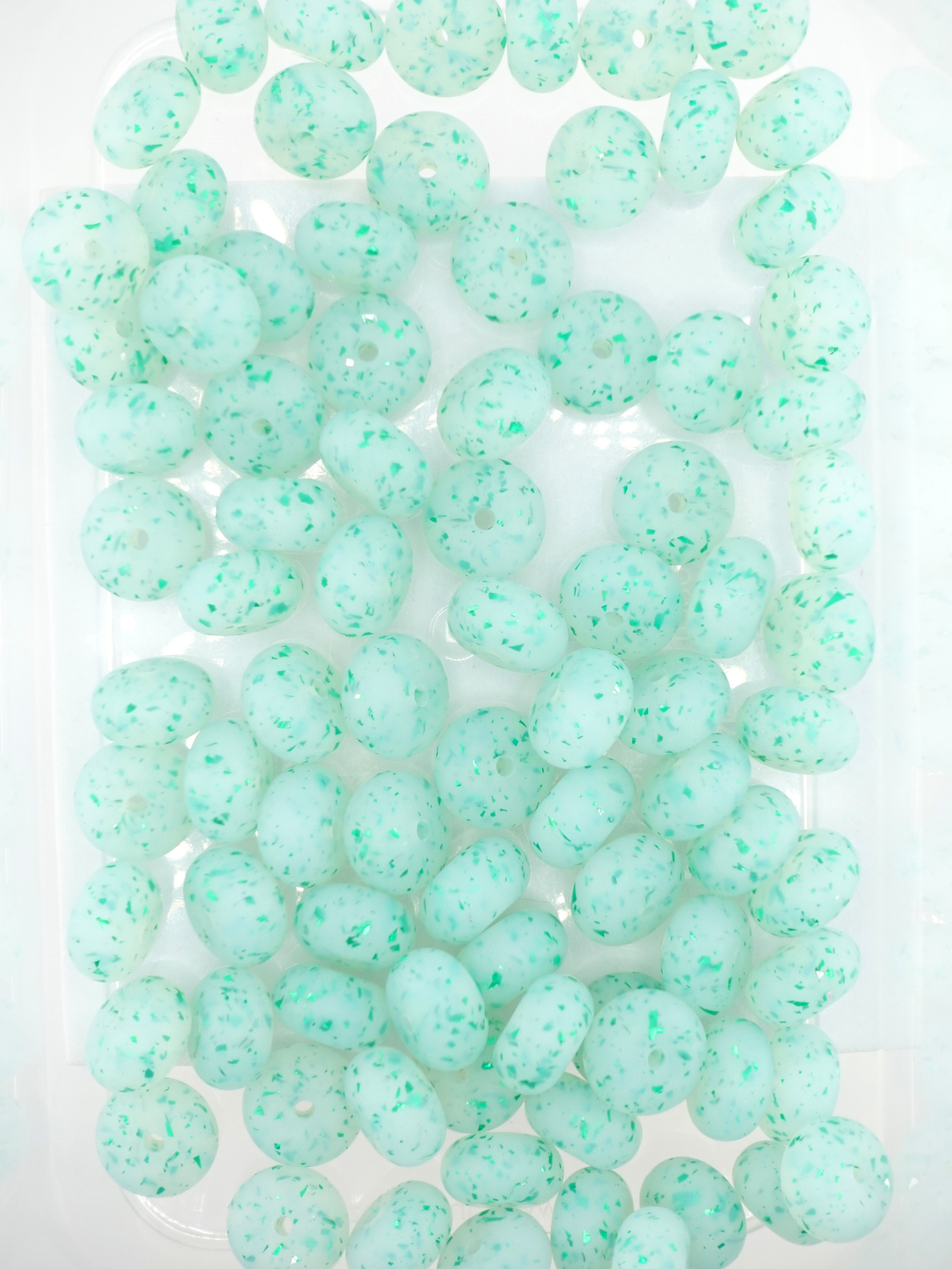 Collection of  green silicone spacers with confetti design and jelly finish