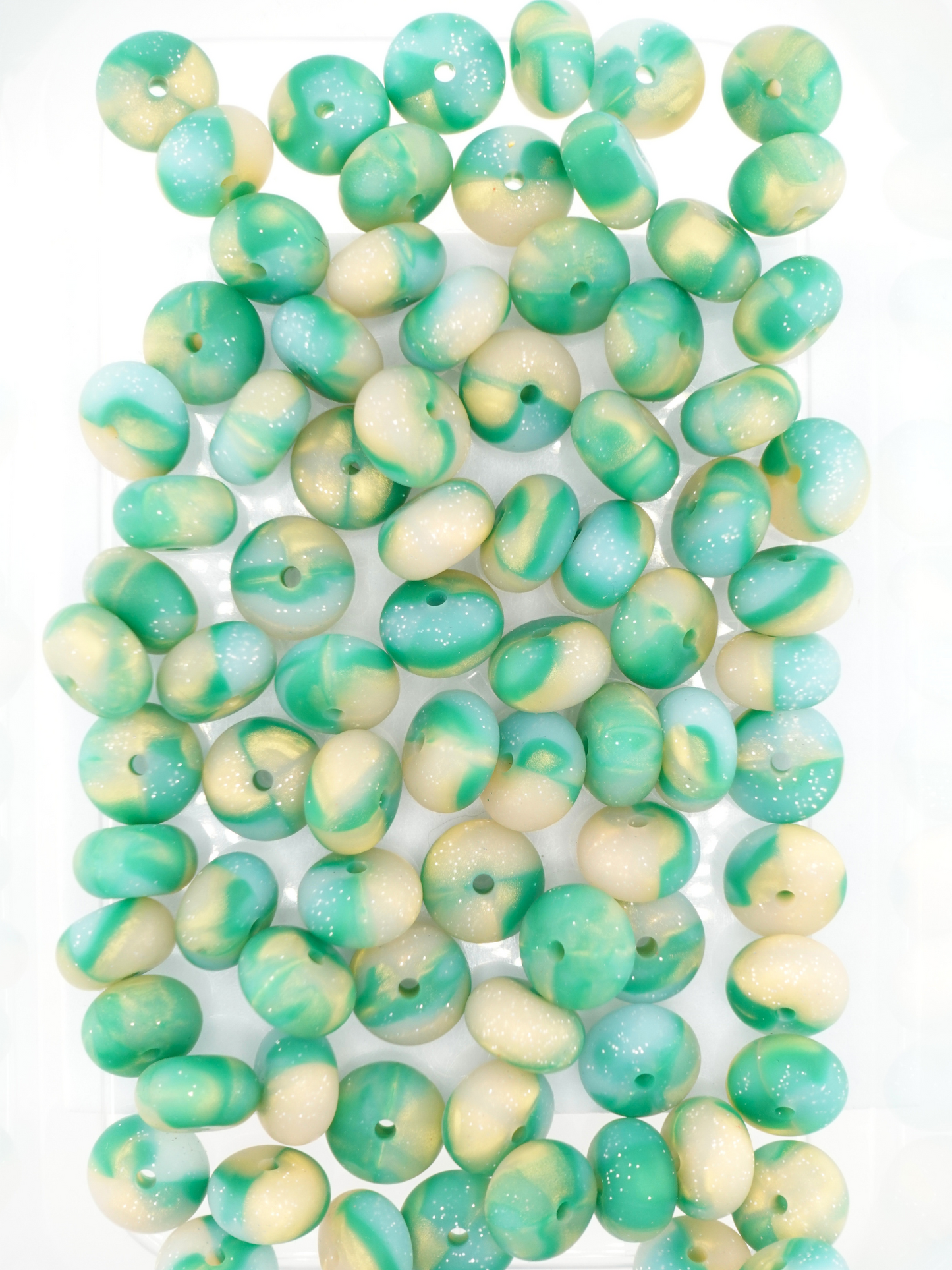 Collection of green and gold silicone spacers with swirl design