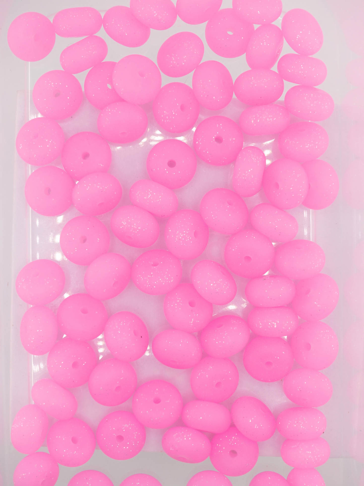 Collection of hot pink colored silicone spacers with glitter