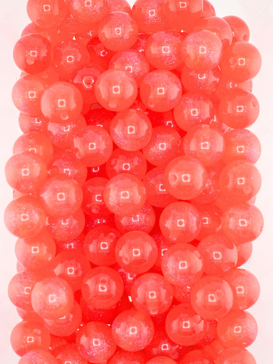 Collection of red colored beads with a galaxy shimmer