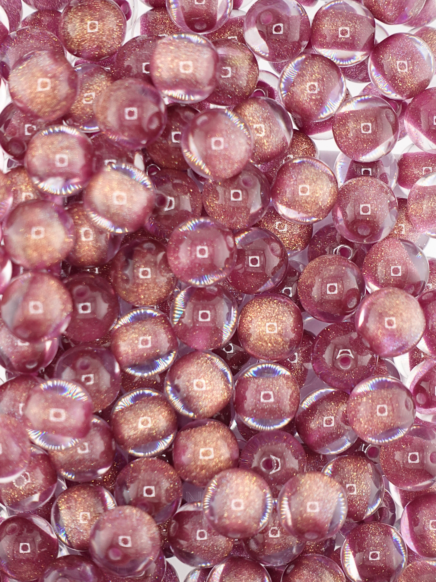 Collection of burgundy colored gold glitter filled beads