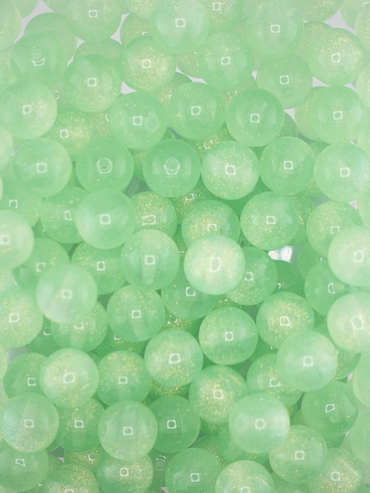 Collection of green colored beads with gold glitter