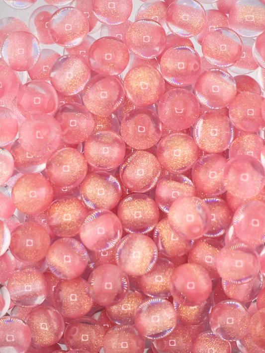 Collection of pink colored glitter beads with a gold finish