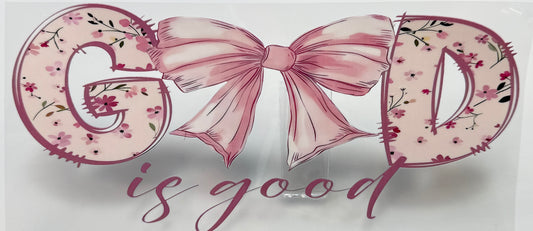 Decorative sign with 'GOD is good' text and a pink bow 
