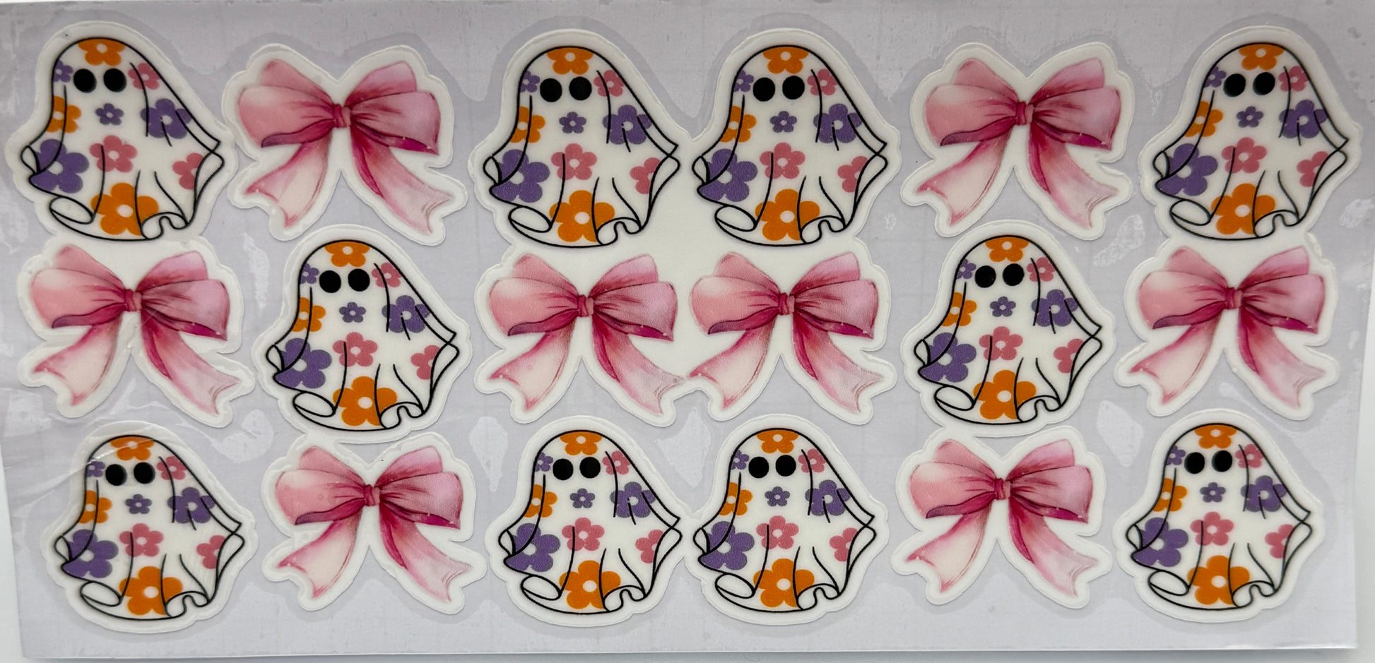 Set of decorative stickers featuring ghosts with floral patterns and pink bows