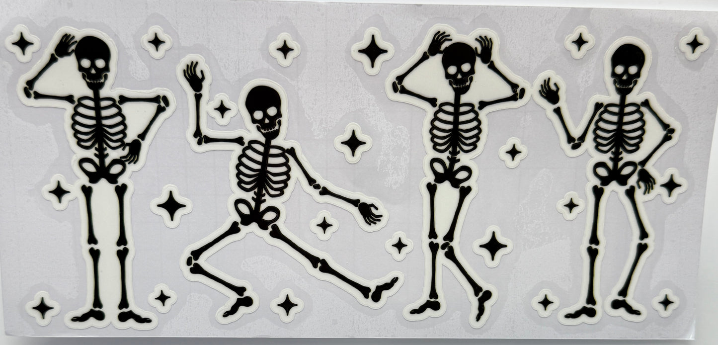 Set of four dancing skeleton figures with star decorations 