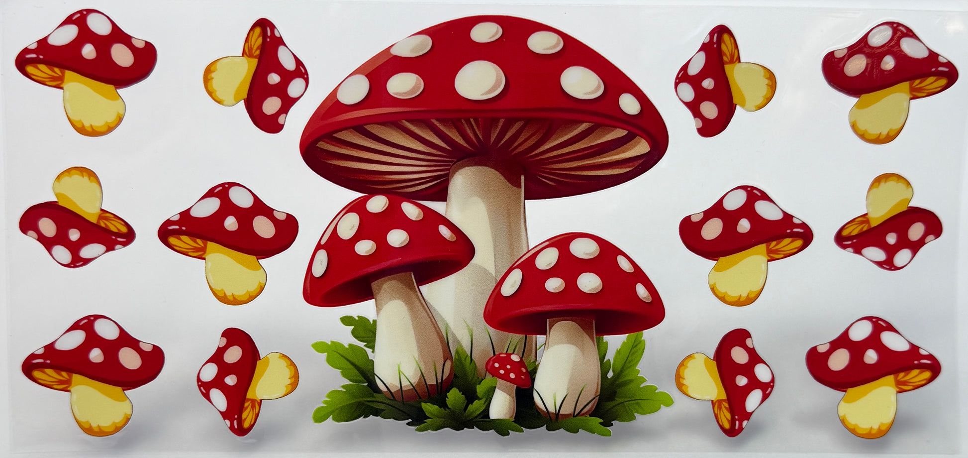 Red and white polka dot mushrooms with green grass 