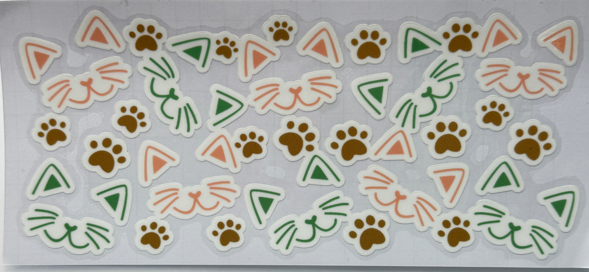 Set of animal-themed stickers with paw prints, triangles, and cat faces 