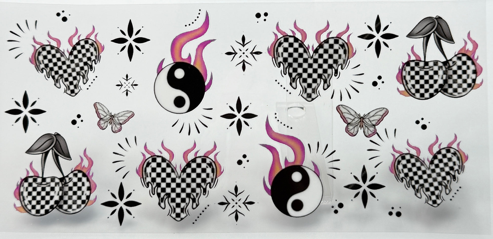 Decorative design with checkered hearts, yin yang symbols, and butterflies 