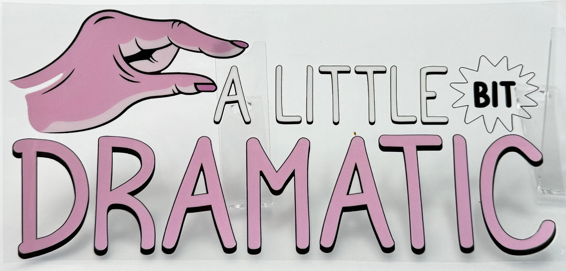 Cartoon hand with pink glove holding up a sign that says 'A Little Bit Dramatic' 