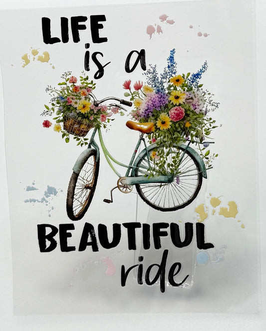 Bicycle with flowers and 'Life is a Beautiful Ride' text 