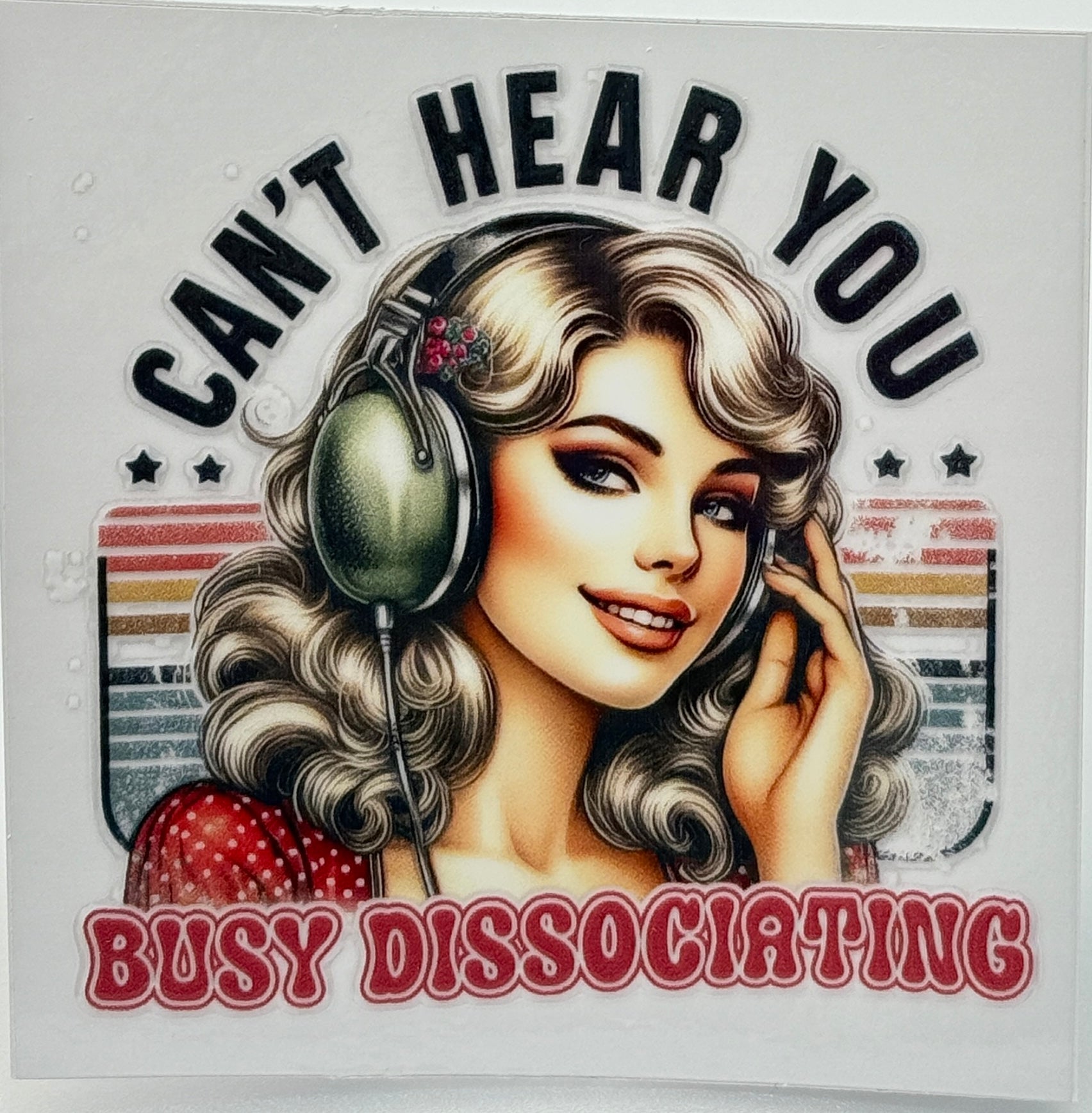 Illustration of a woman with headphones and text 'Can't Hear You Busy Dissociating' 