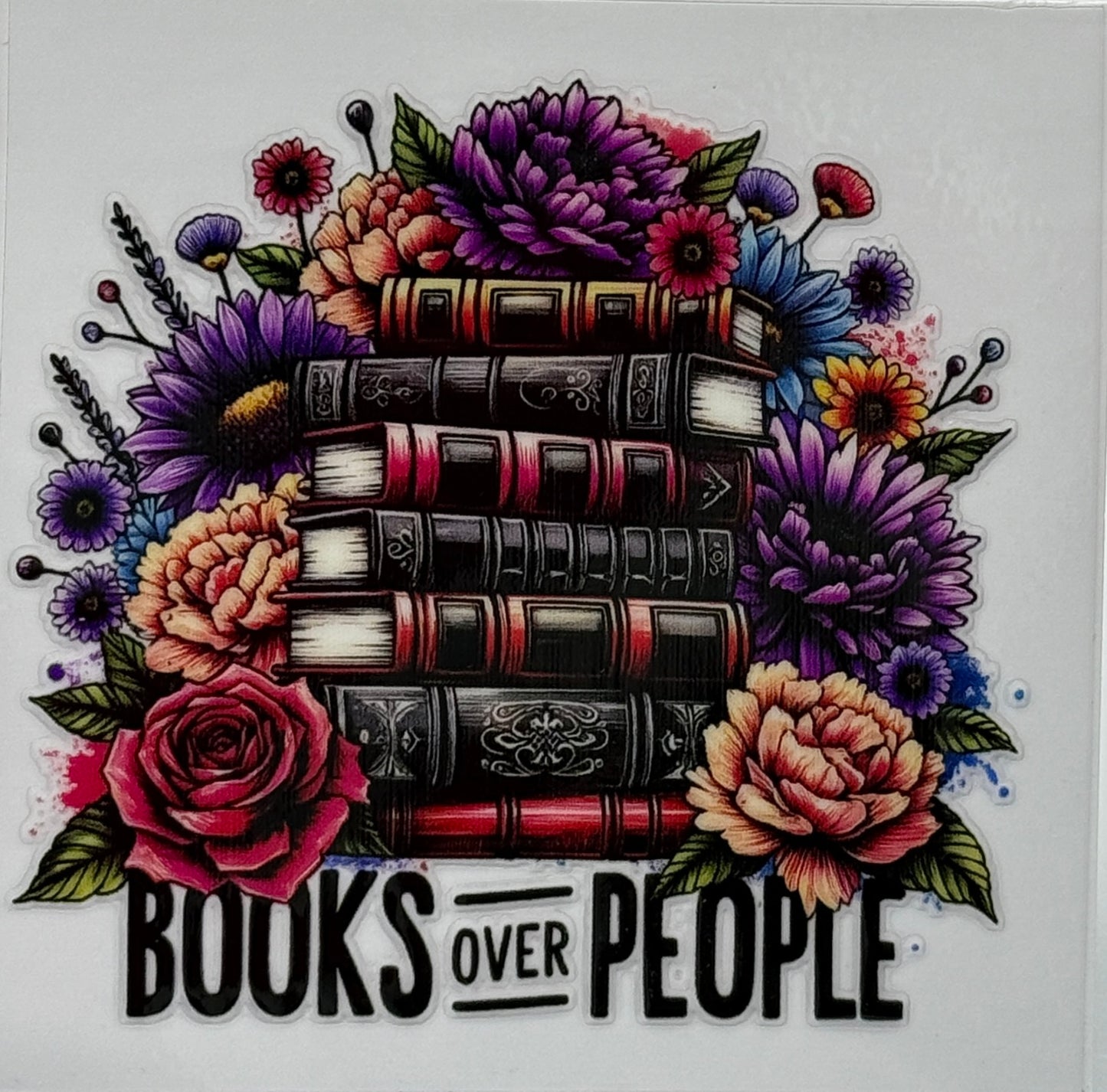 Stack of books surrounded by flowers with 'Books Over People' text 