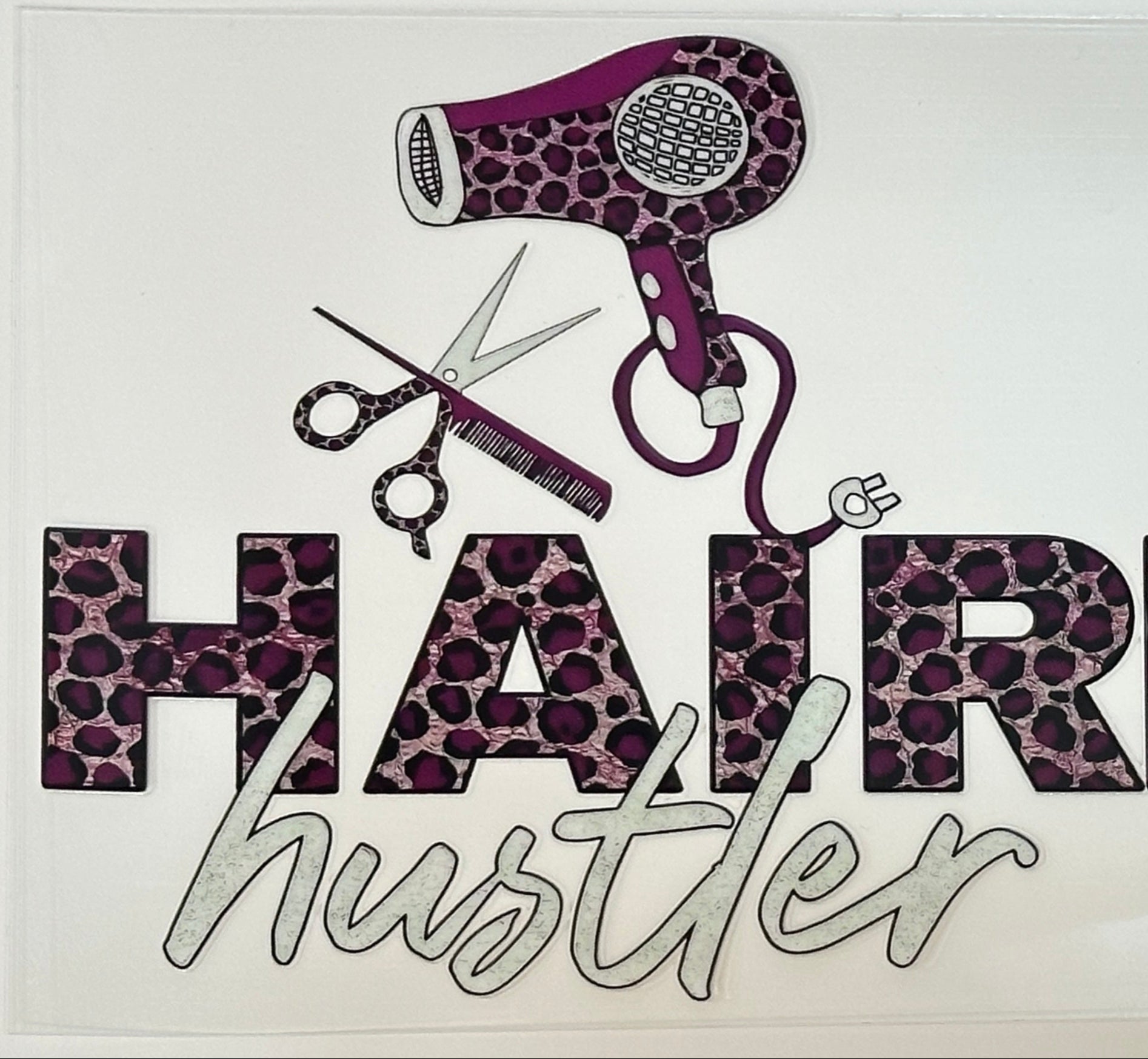 Decorative sign with hairdryers, scissors, and 'Hair Hair Hustler' text on a white background