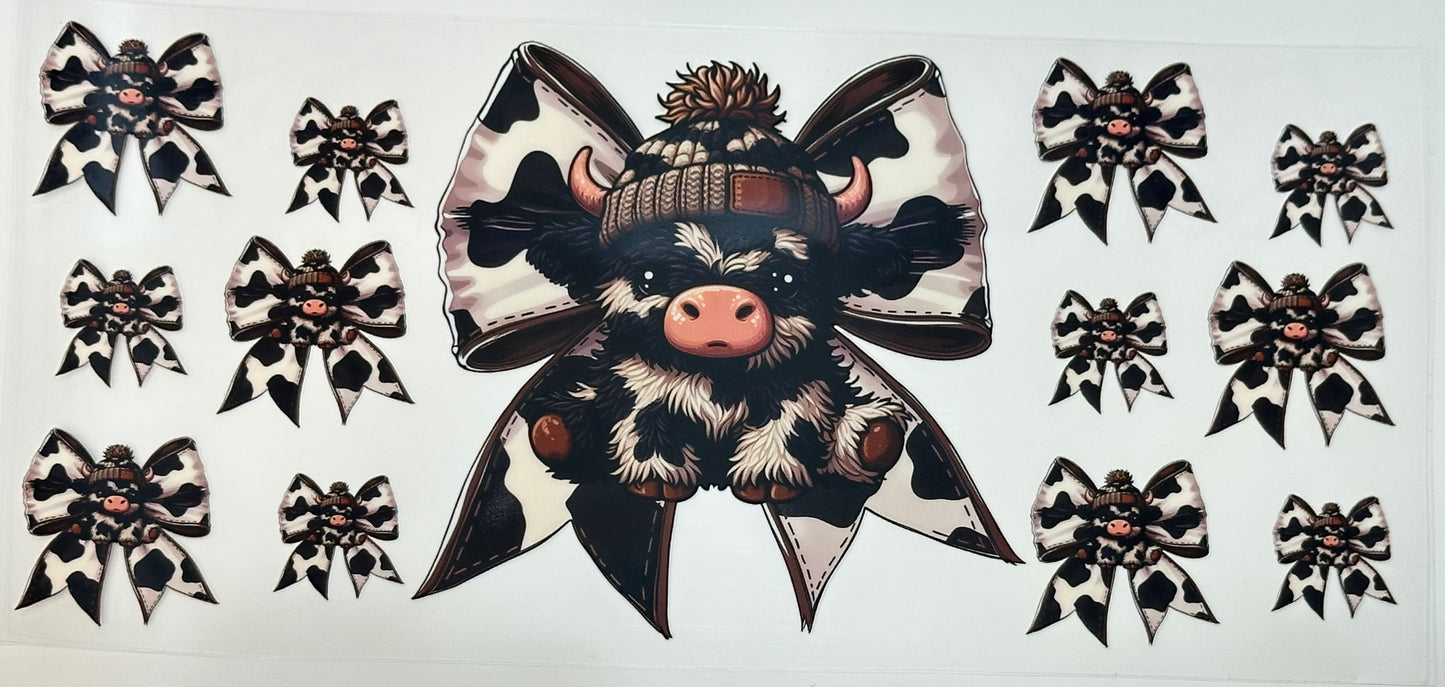 Decorative sticker with a cow wearing a large bow and hat 