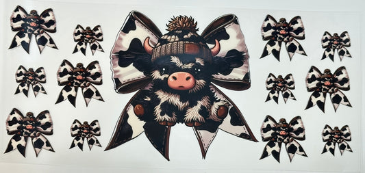 Decorative sticker with a cow wearing a large bow and hat 