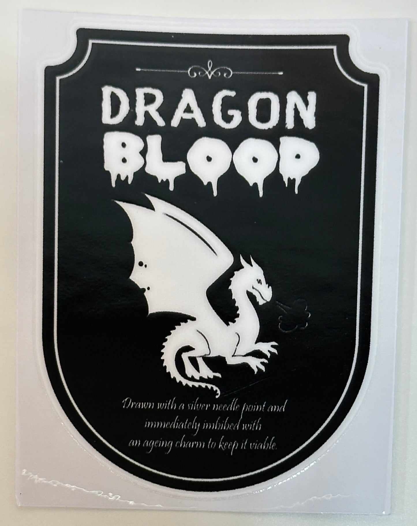 Sticker with dragon design and 'Dragon Blood' text on a black background