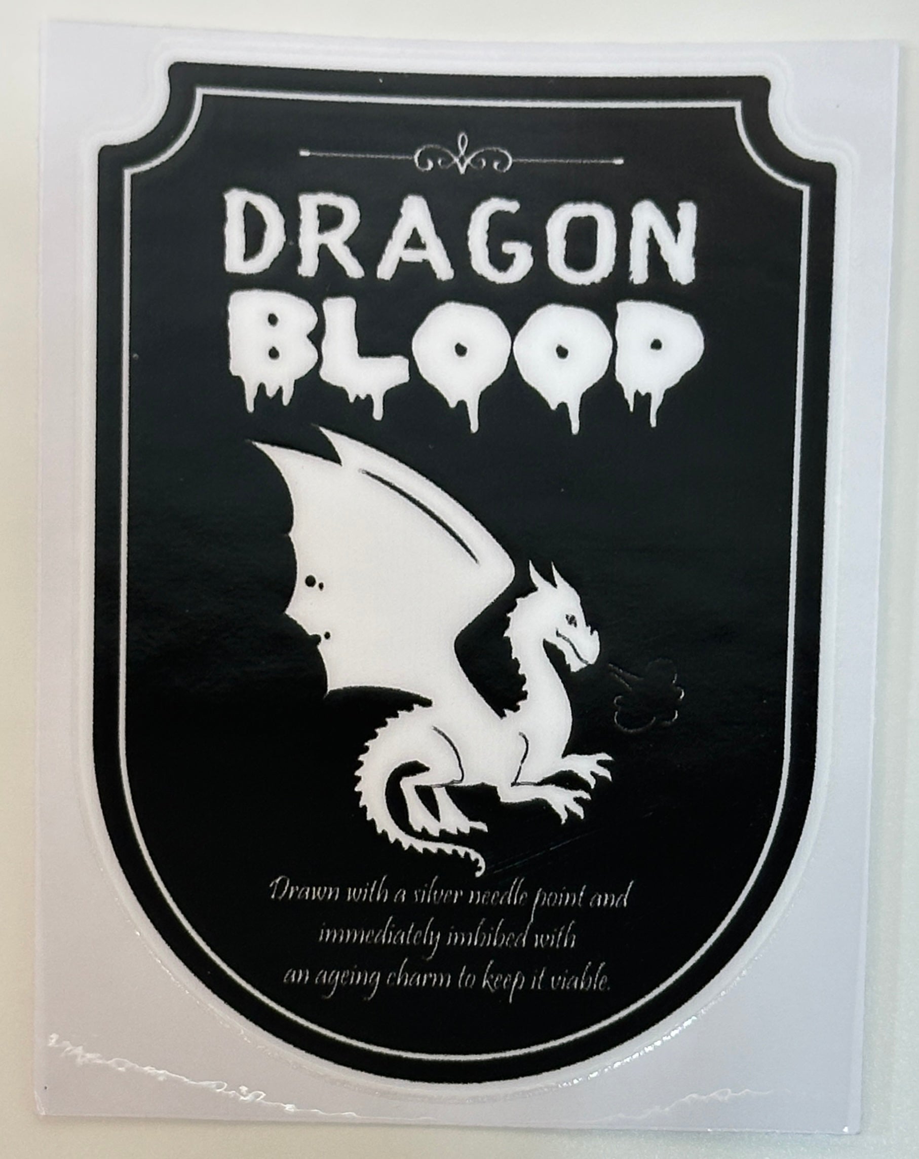 Sticker with dragon design and 'Dragon Blood' text on a black background