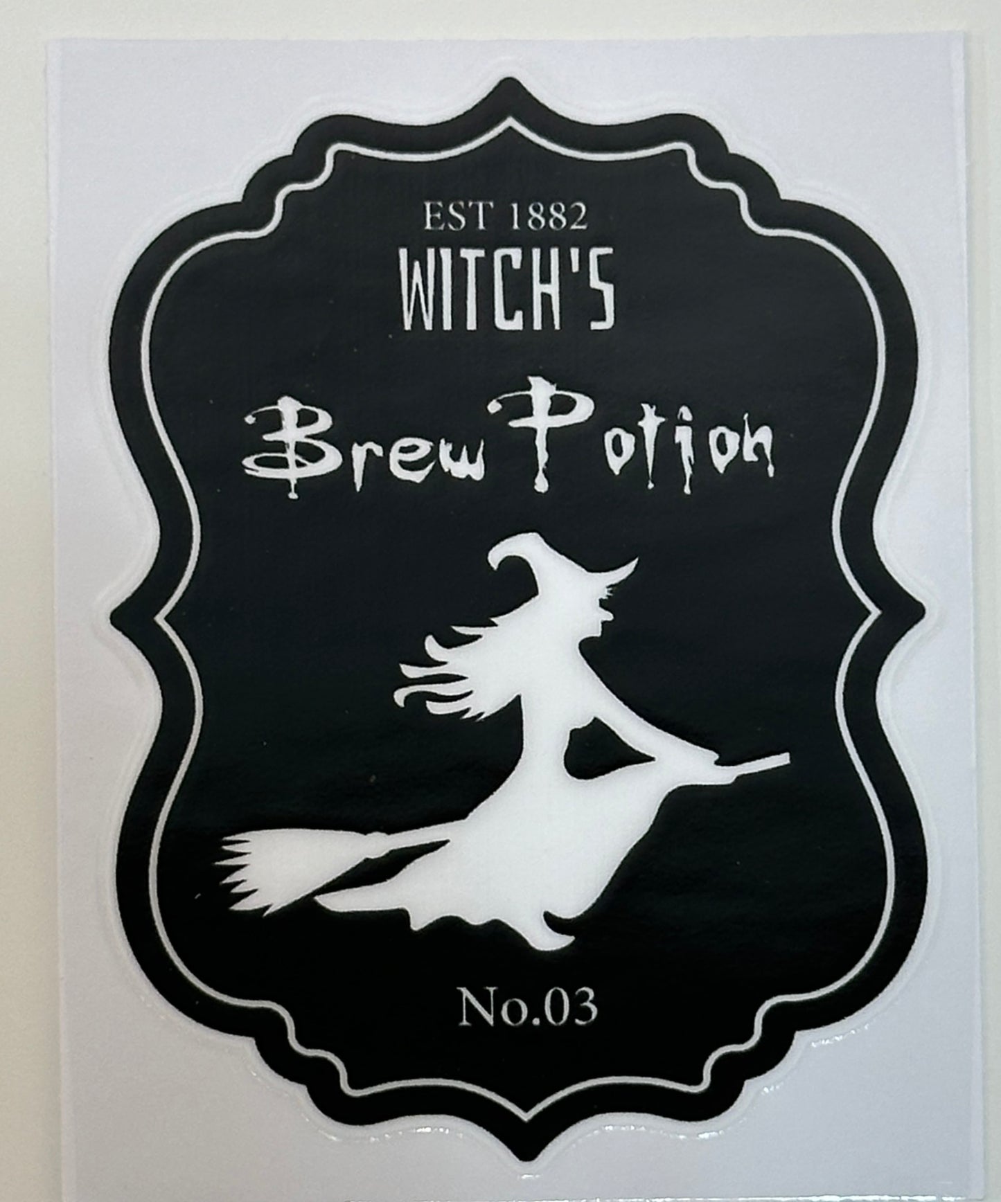Decorative sign with witch's silhouette and 'Witch's Brew Potion' text 