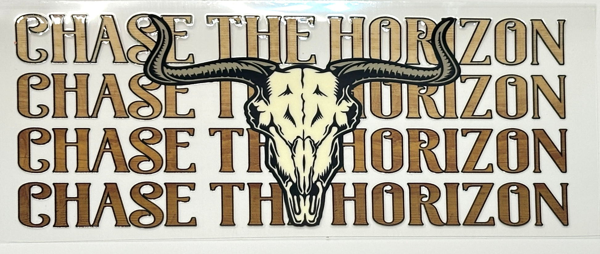 Decorative sign with bull skull and 'Chase the Horizon' text.