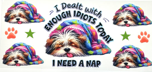 Dog wearing a colorful hoodie with text 'I Dealt with Enough Idiots Today, I Need a Nap' surrounded by paw prints and stars.