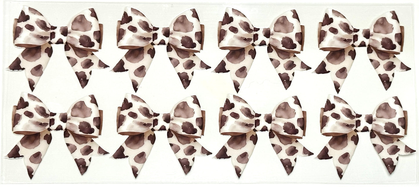 Multiple leopard print hair bows arranged in a grid