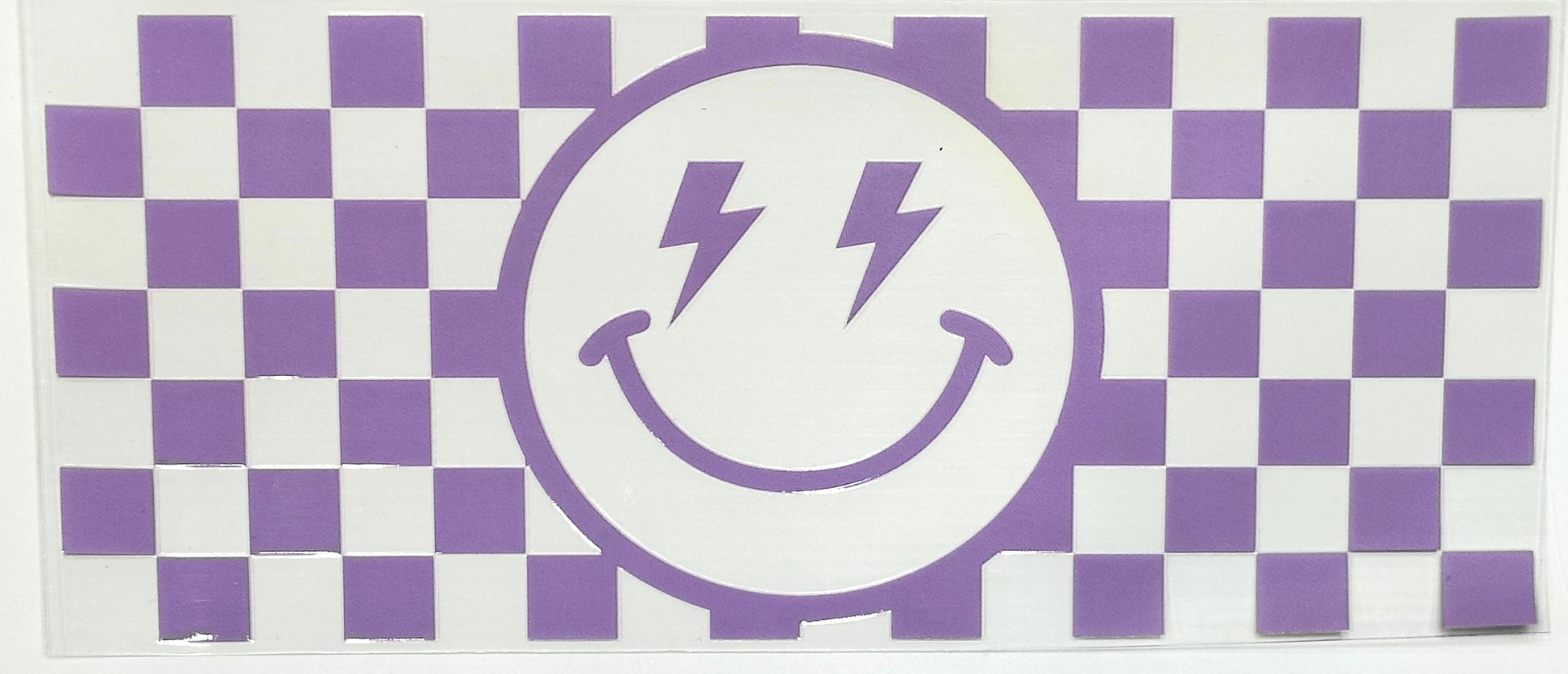 Checkered pattern with a smiley face design featuring lightning bolts