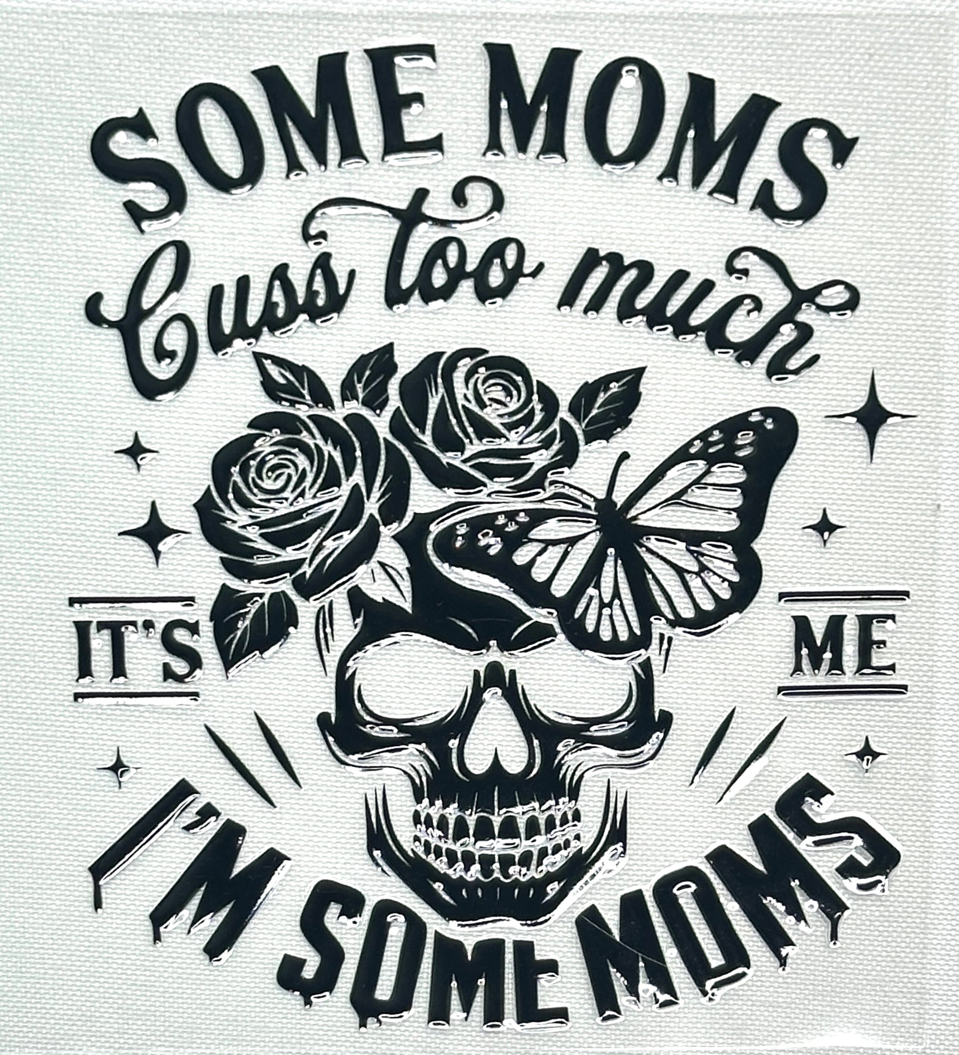 Skull design with roses and a butterfly, surrounded by text 