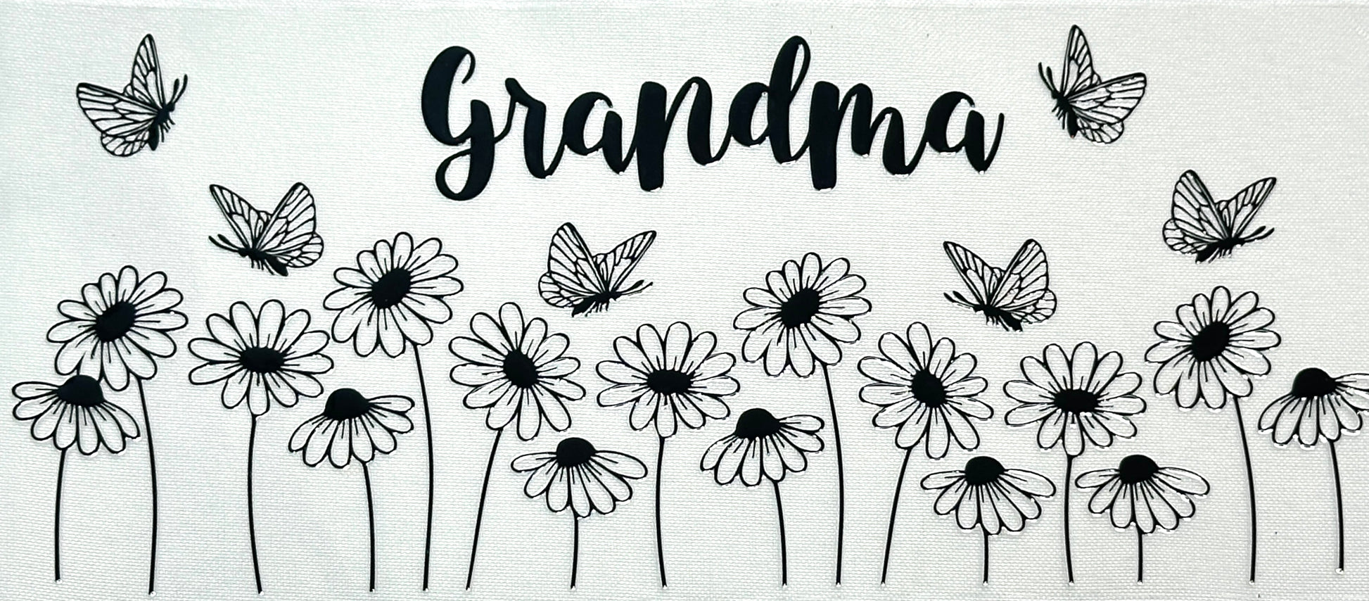 Black and white illustration of flowers and butterflies with 'Grandma' text 