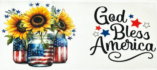 Decorative sign with sunflowers in American flag jars and 'God Bless America' text.