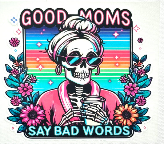 Skeleton character with sunglasses and coffee cup against a rainbow background with floral elements and text 'Good moms say bad words'.