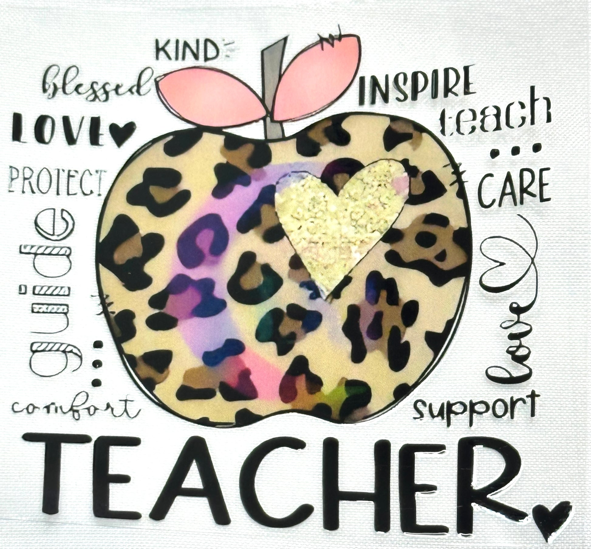 Leopard print apple with a heart and text around it on a white background