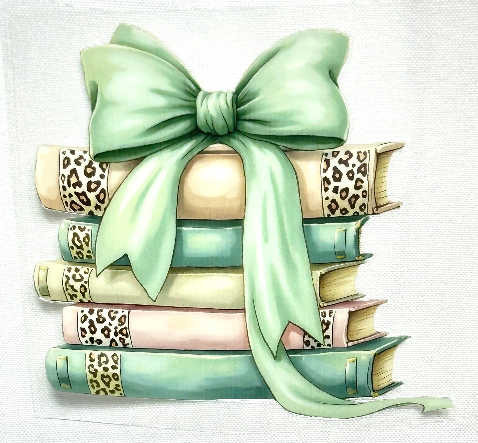 Stack of books with a green bow on a light background