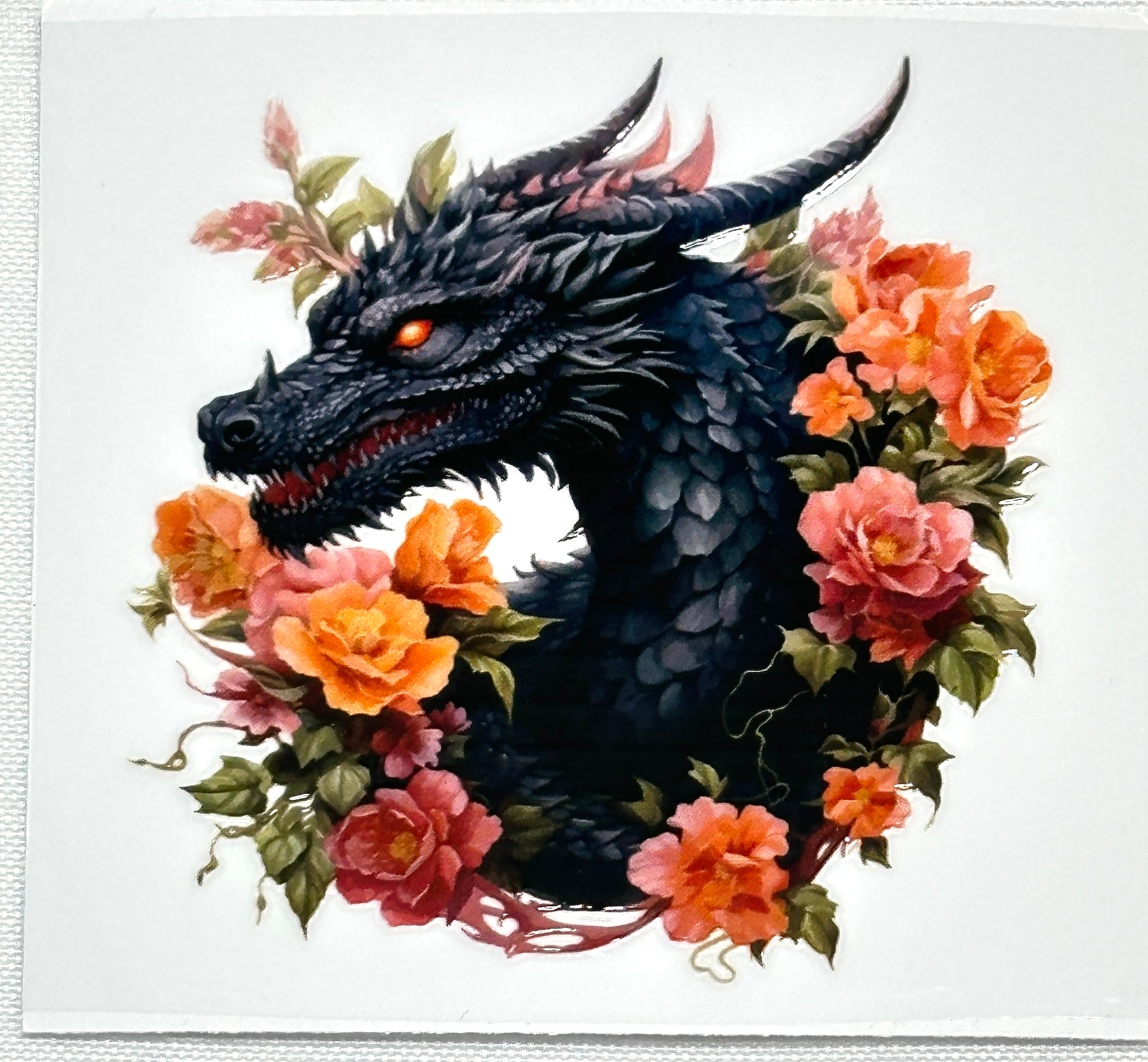 Black dragon surrounded by colorful flowers on a white background