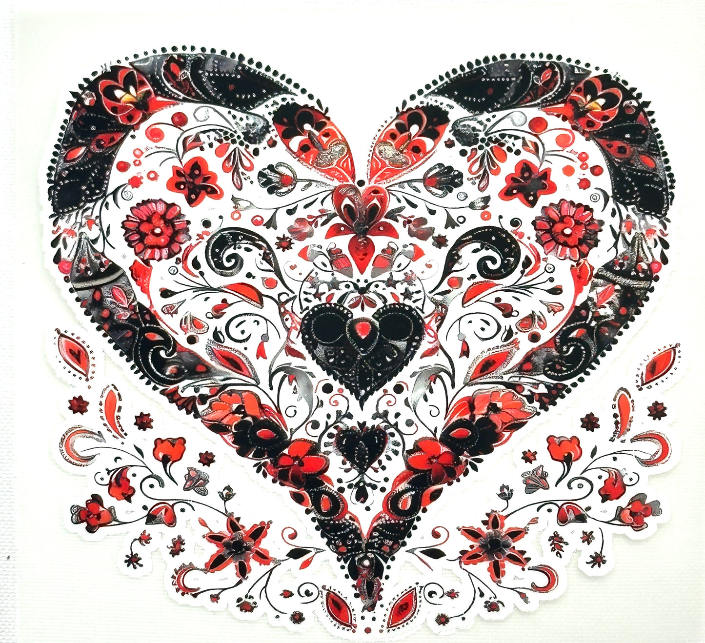 Decorative heart design with black, red, and white patterns on a white background