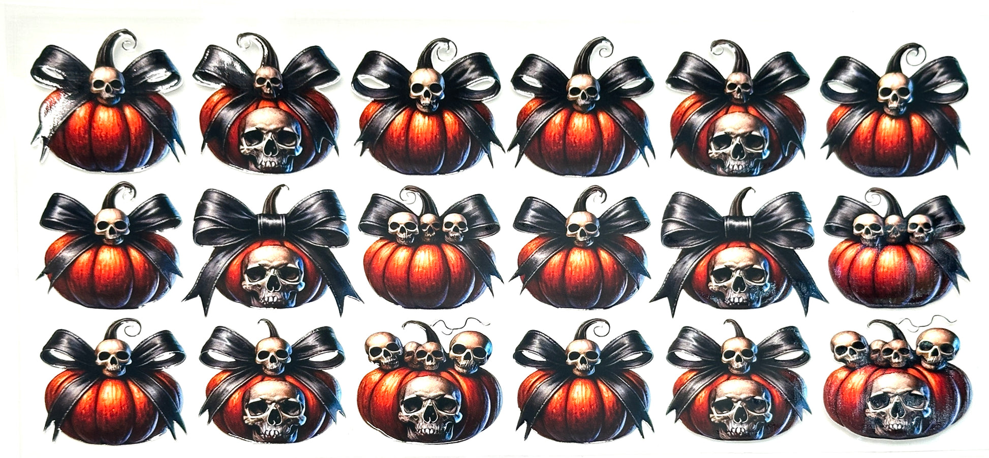 Decorative stickers with pumpkins, skulls, and ribbons on a white background