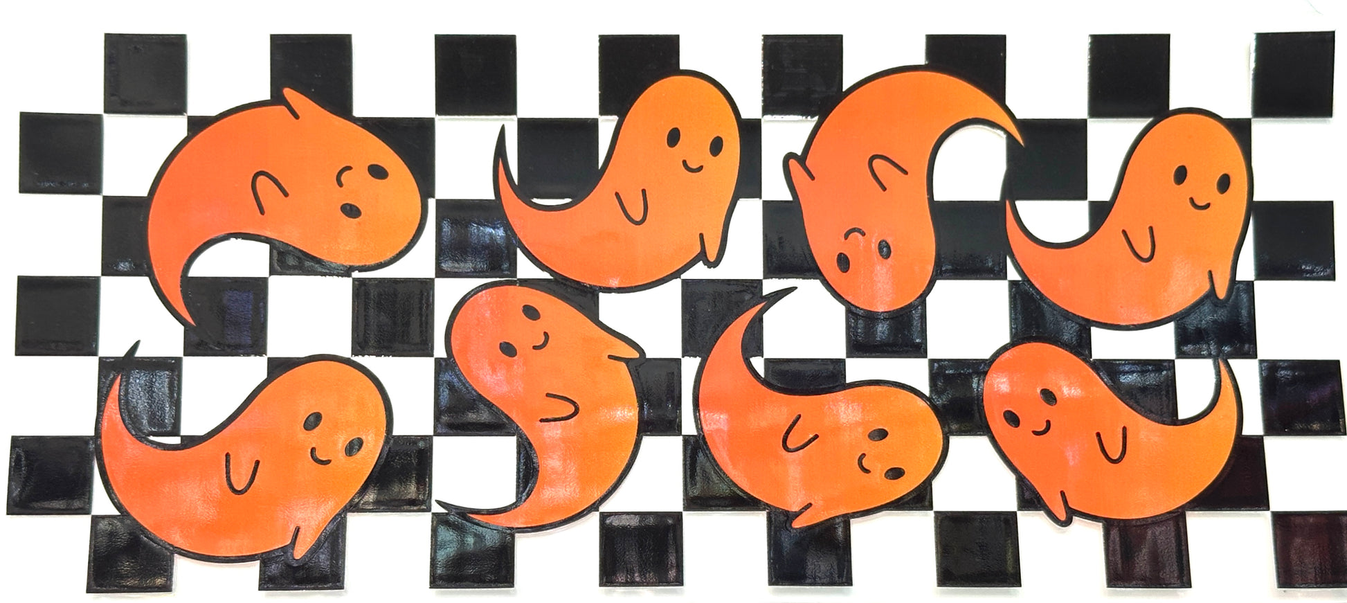 Orange ghost illustrations on a black and white checkered background