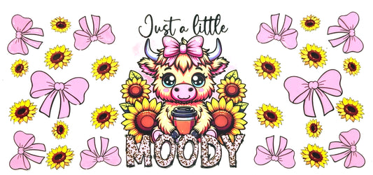 Cartoon cow with a coffee cup surrounded by sunflowers and pink bows with text 'Just a little MOODY'.