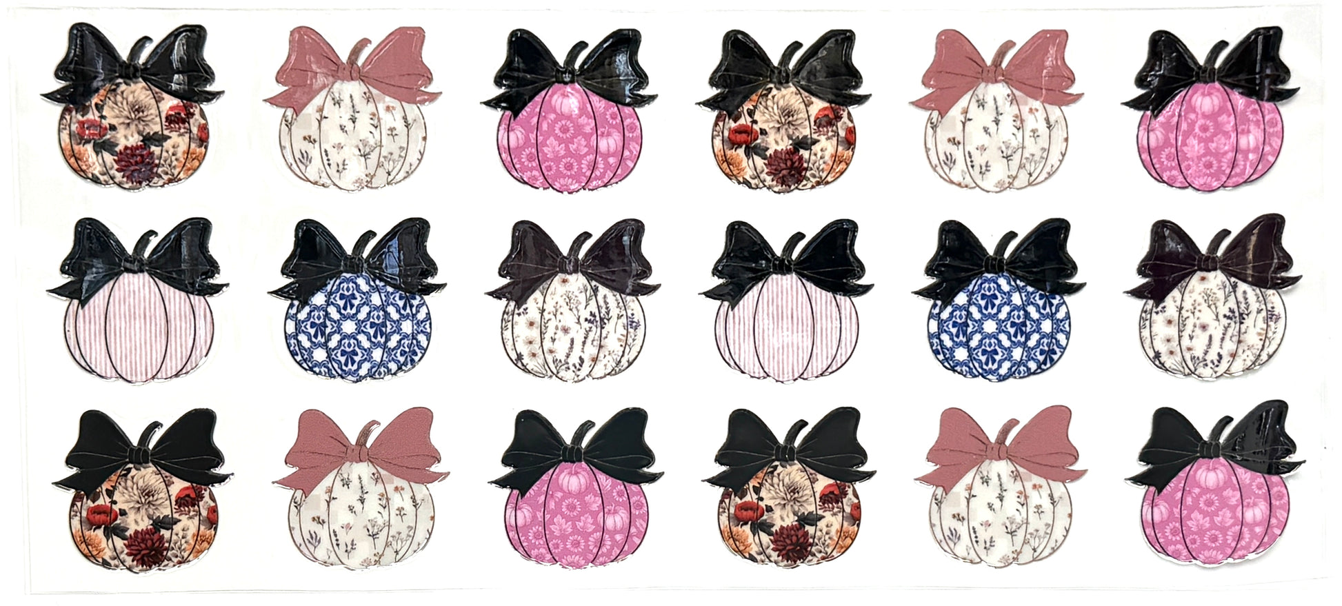 Set of decorative pumpkins with bows on a white background