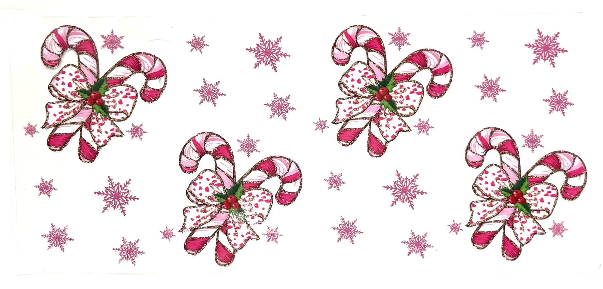 Decorative candy canes with bows and snowflakes on a white background