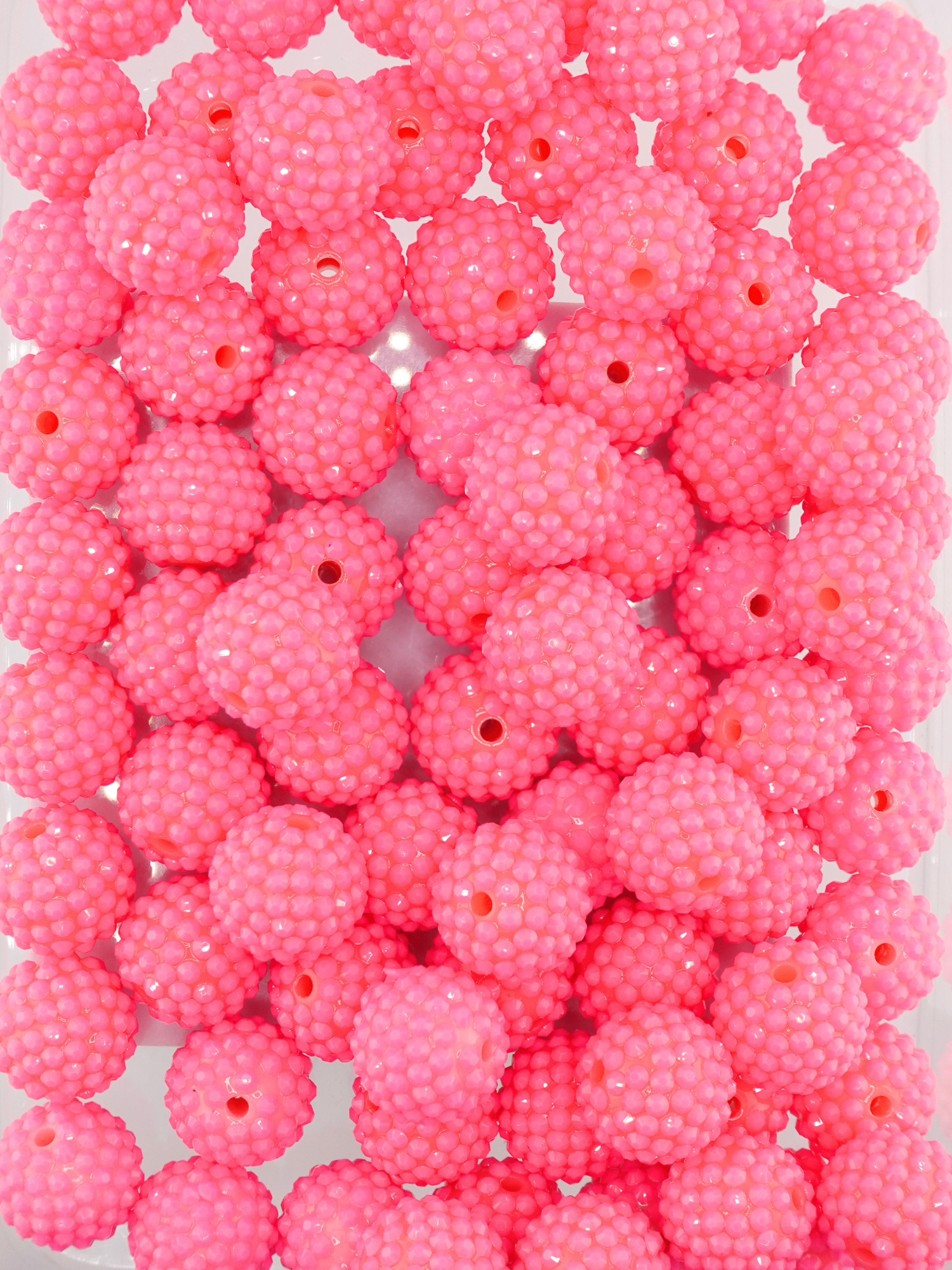 Collection of hot pink colored beads with rhinestone texture