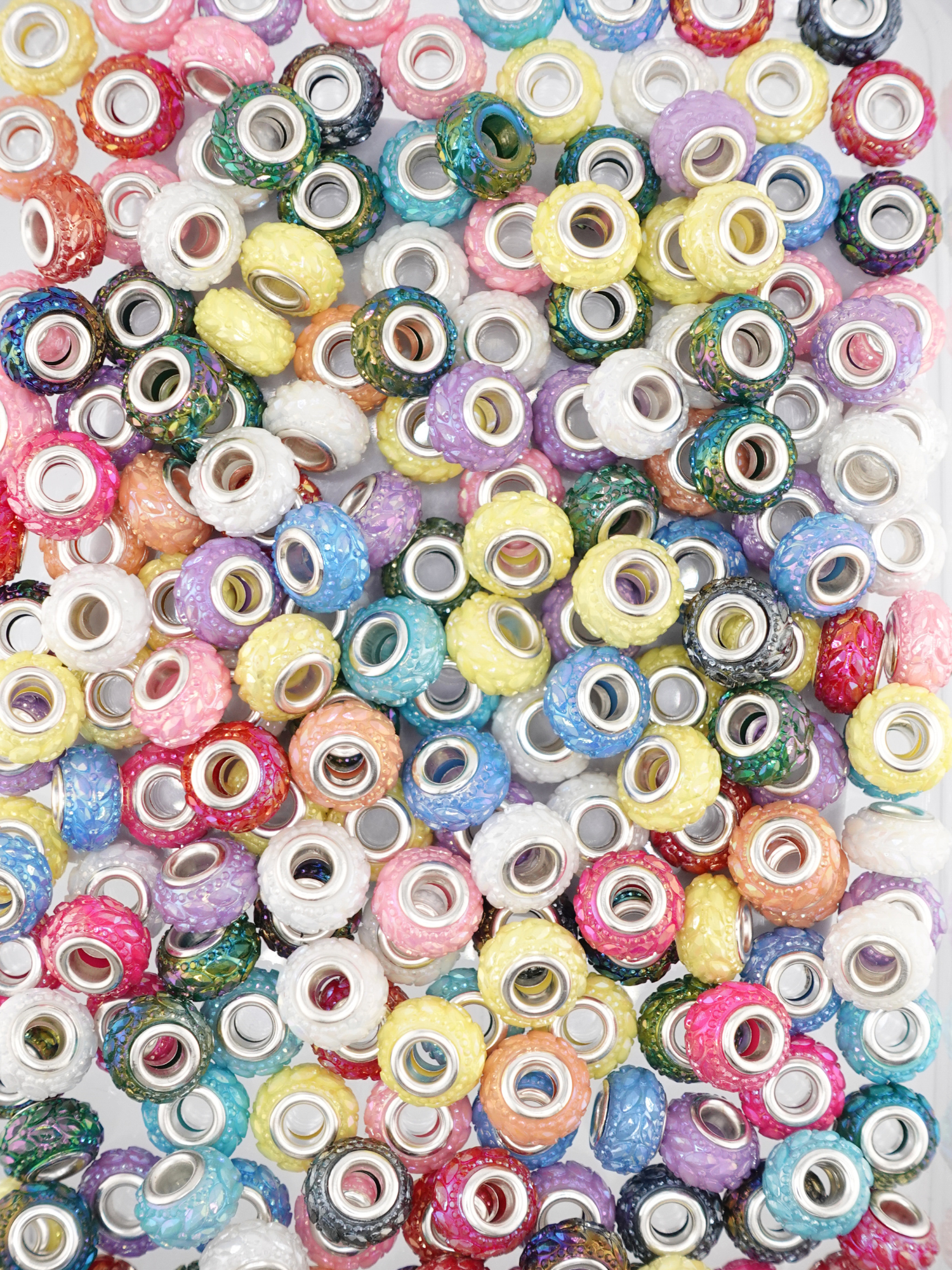 Collection of different colored spacers with a textured leaf design