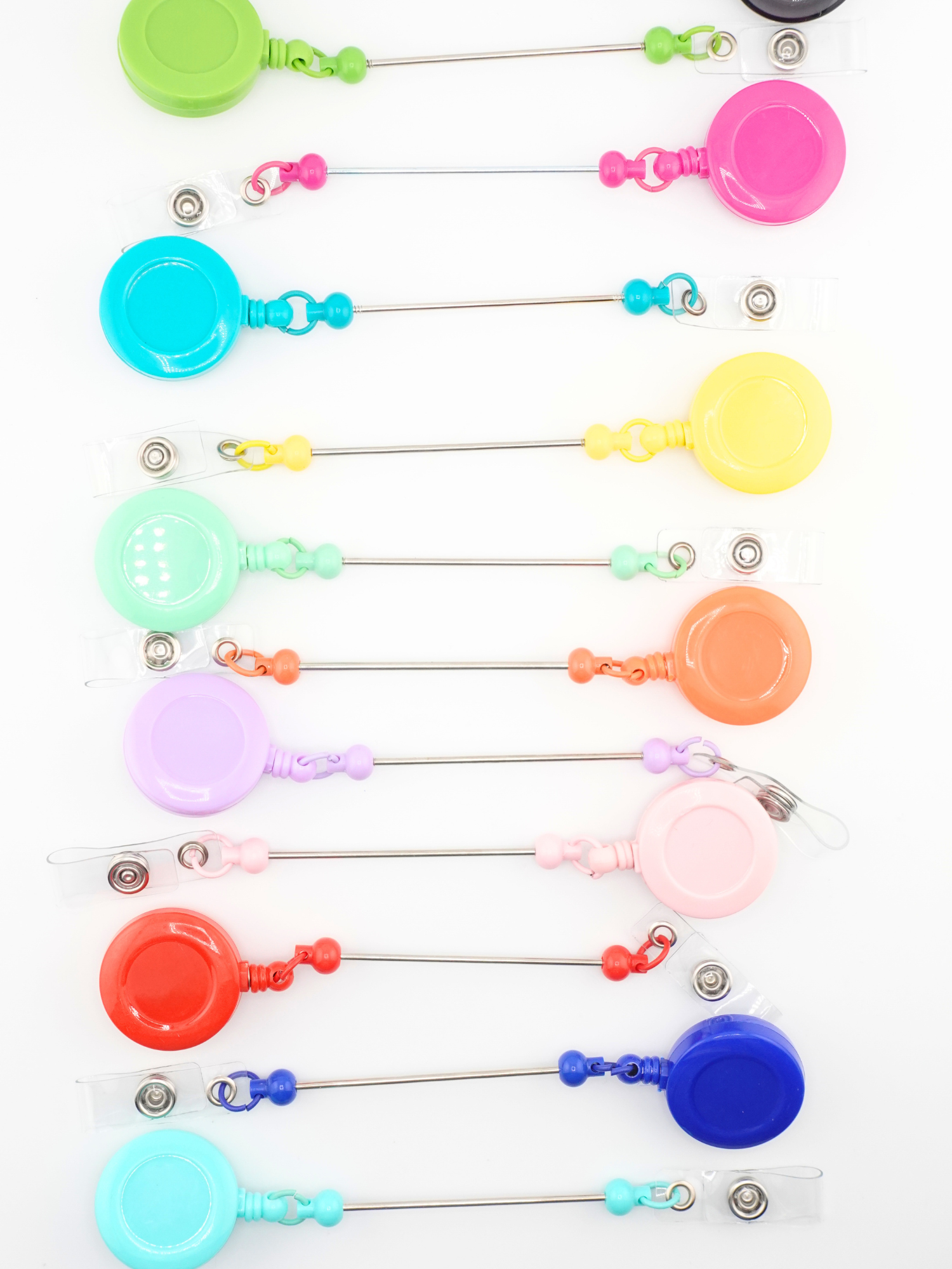Collection of beadable badges in different colors.