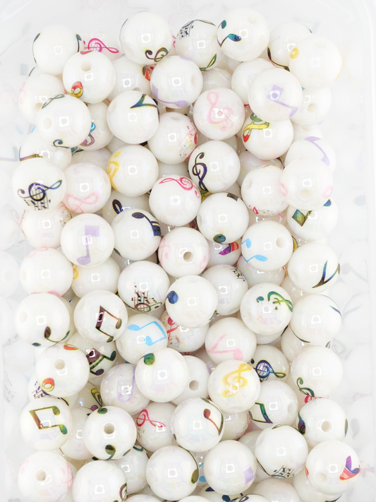 Collection of white colored beads featuring different music note designs