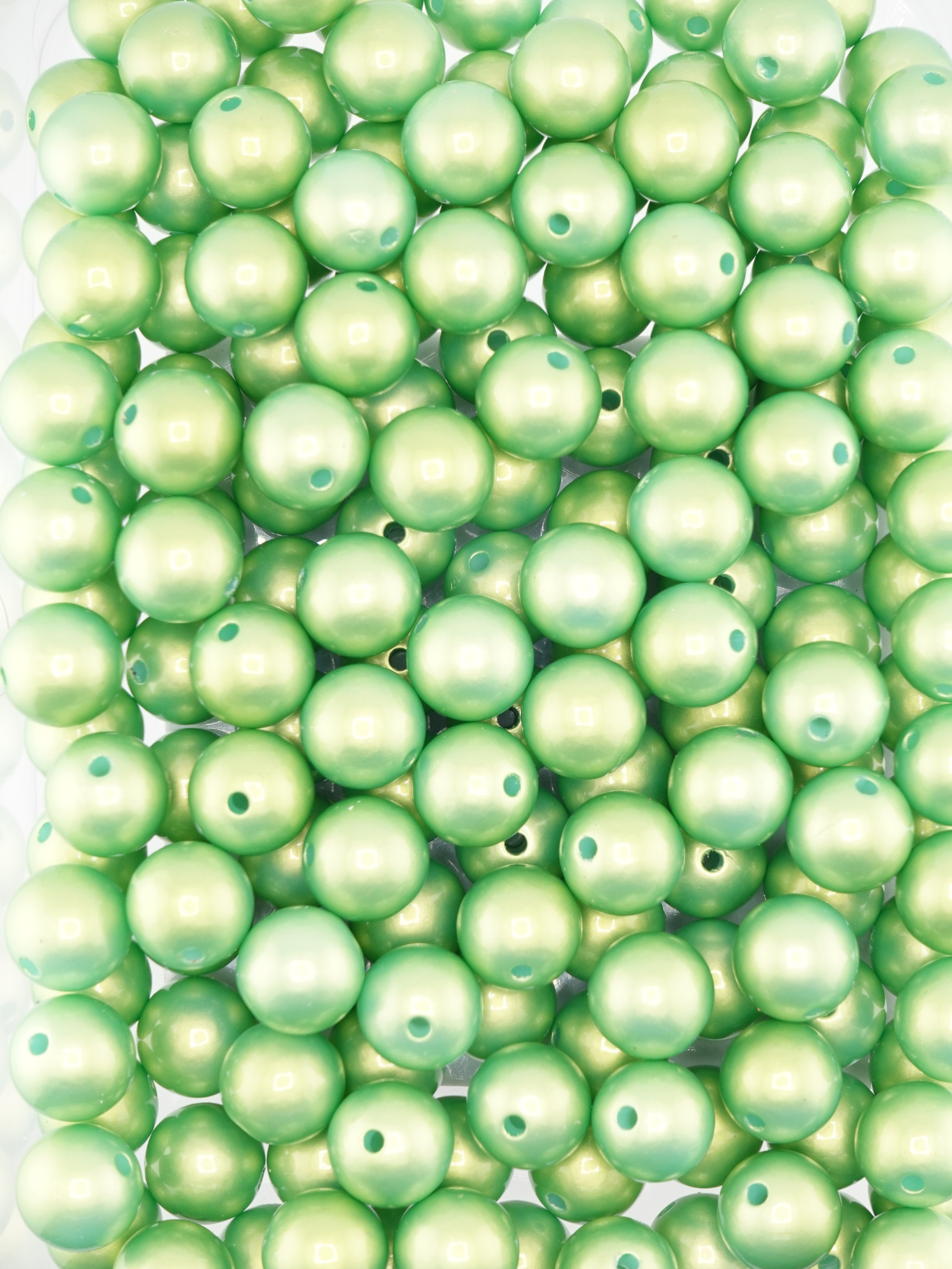 Collection of green colored beads with a pearl shimmer finish